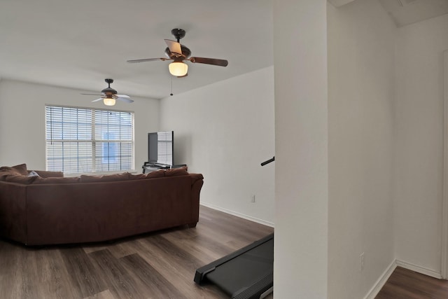 living room featuring ceiling fan and dark hardwood / wood-style flooring