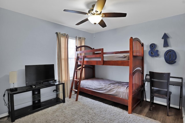 bedroom featuring ceiling fan, baseboards, and dark wood-style flooring