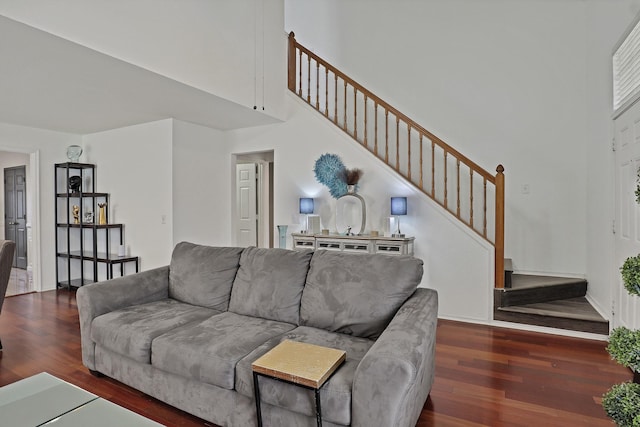 living room featuring dark hardwood / wood-style flooring and a high ceiling