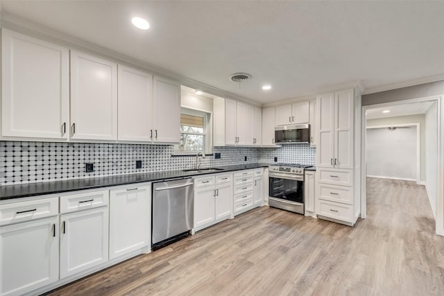 728 Del Dr, Denton, TX 76207 - kitchen featuring stainless steel appliances, a sink, white cabinets, crown molding, and tasteful backsplash