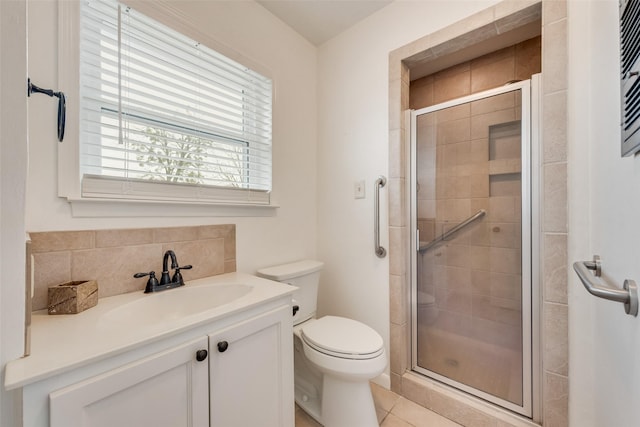 bathroom featuring walk in shower, vanity, toilet, and backsplash