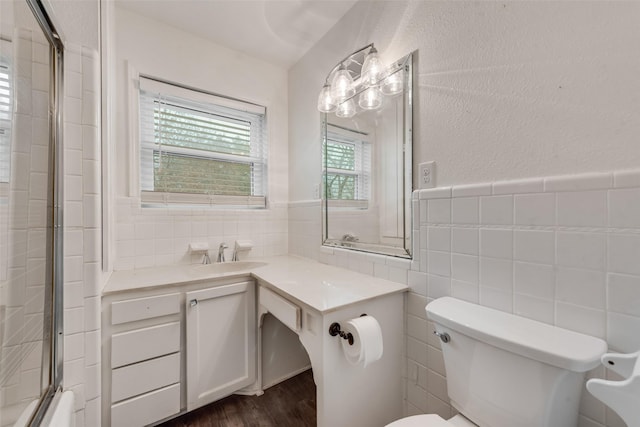 728 Del Dr, Denton, TX 76207 - full bath with tile walls, toilet, wood finished floors, vanity, and a chandelier