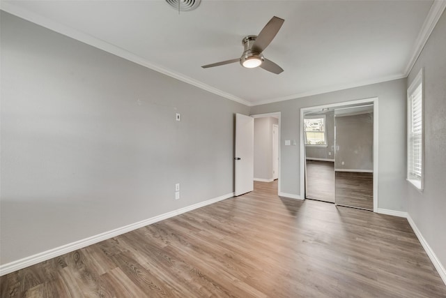 728 Del Dr, Denton, TX 76207 - unfurnished bedroom with light wood-style flooring, baseboards, ornamental molding, a ceiling fan, and a closet