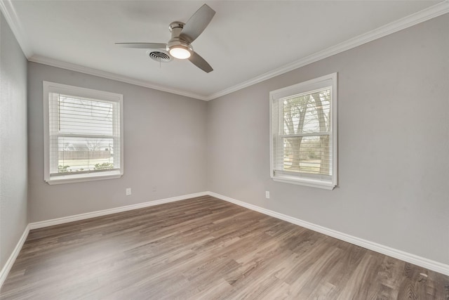 spare room with ornamental molding, light hardwood / wood-style floors, and ceiling fan