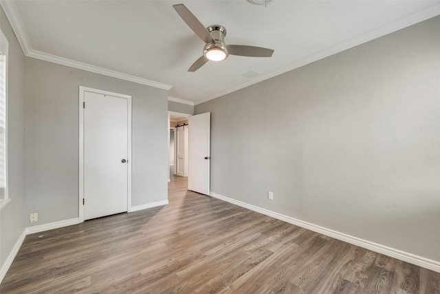 728 Del Dr, Denton, TX 76207 - unfurnished bedroom featuring wood finished floors, baseboards, ornamental molding, and ceiling fan