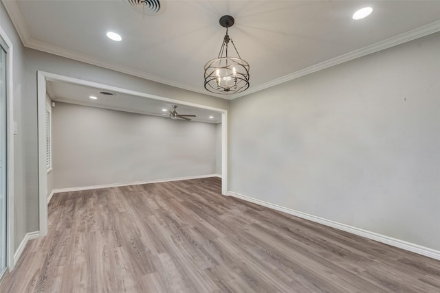 empty room with hardwood / wood-style floors, ceiling fan with notable chandelier, and ornamental molding