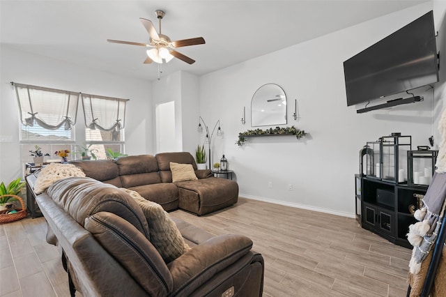 living room with ceiling fan and light hardwood / wood-style flooring