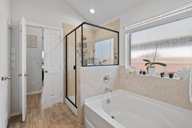 bathroom featuring separate shower and tub and lofted ceiling