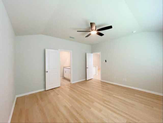 unfurnished bedroom with vaulted ceiling, connected bathroom, ceiling fan, and light hardwood / wood-style floors