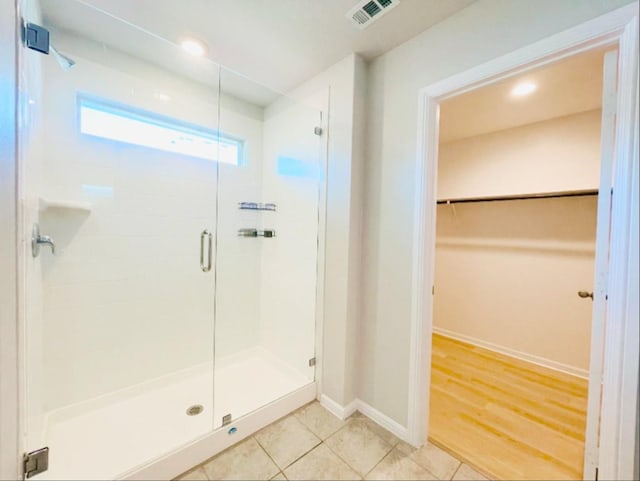 bathroom with walk in shower and tile patterned floors