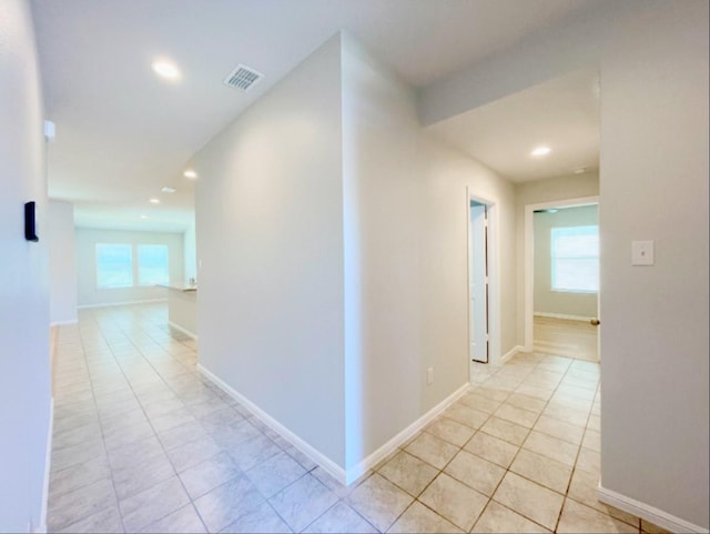 hall featuring light tile patterned floors