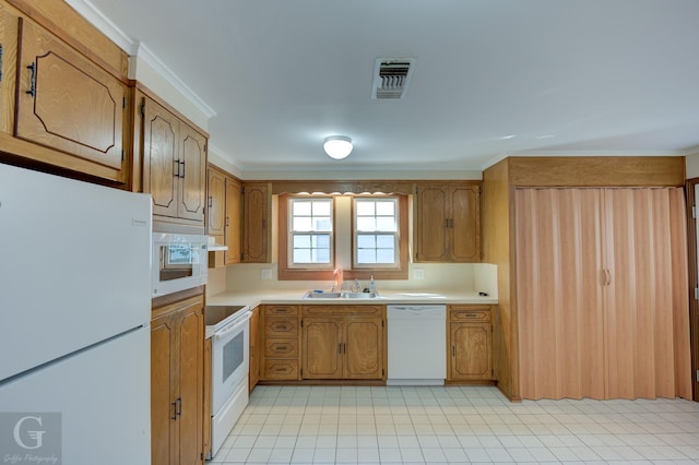 kitchen with crown molding, sink, and white appliances