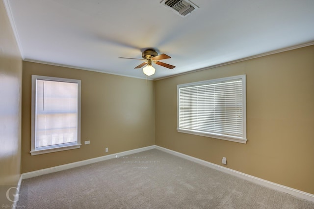 carpeted empty room featuring crown molding, ceiling fan, and a healthy amount of sunlight