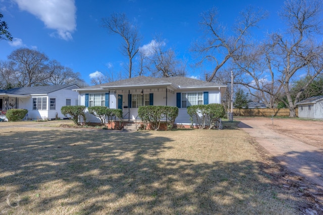 single story home featuring covered porch and a front lawn