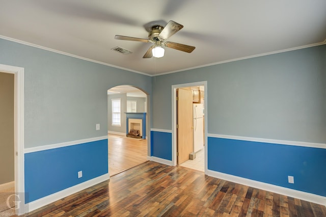 unfurnished room with crown molding, hardwood / wood-style floors, and ceiling fan