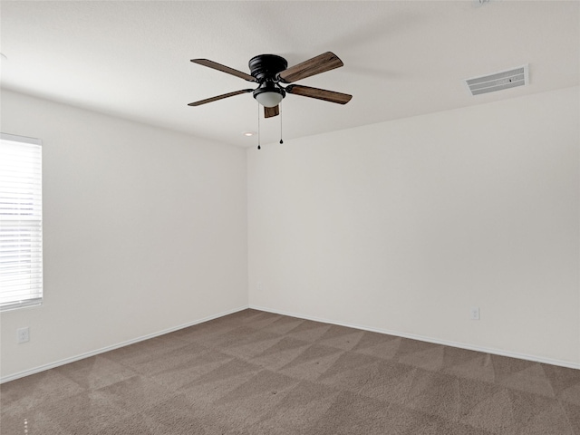 carpeted empty room featuring ceiling fan