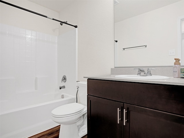 full bathroom with vanity, hardwood / wood-style floors, shower / washtub combination, and toilet