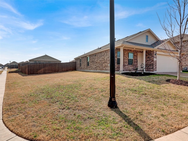 view of side of property featuring a garage and a lawn