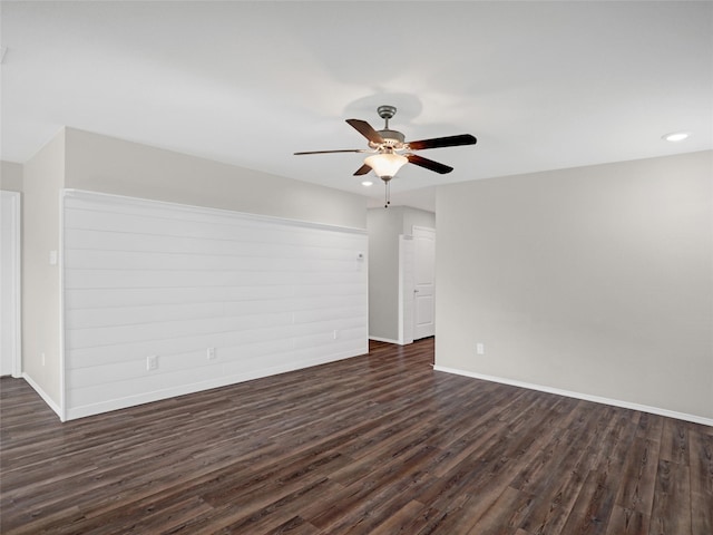 unfurnished room with dark hardwood / wood-style floors and ceiling fan