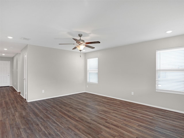 spare room with ceiling fan and dark hardwood / wood-style flooring