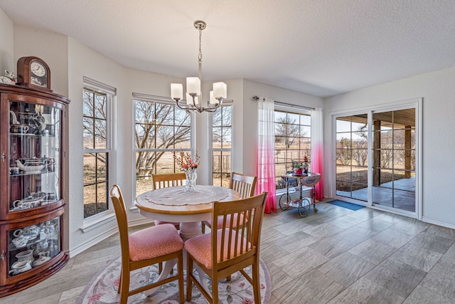 dining room with a chandelier and a textured ceiling