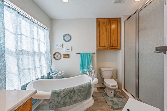 full bathroom featuring vanity, hardwood / wood-style flooring, toilet, and separate shower and tub