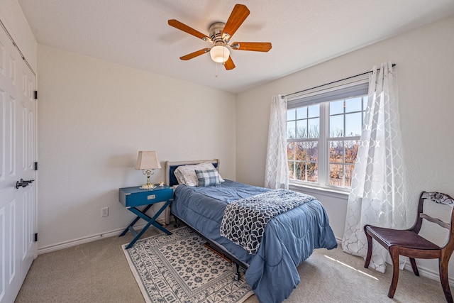 bedroom featuring light carpet and ceiling fan