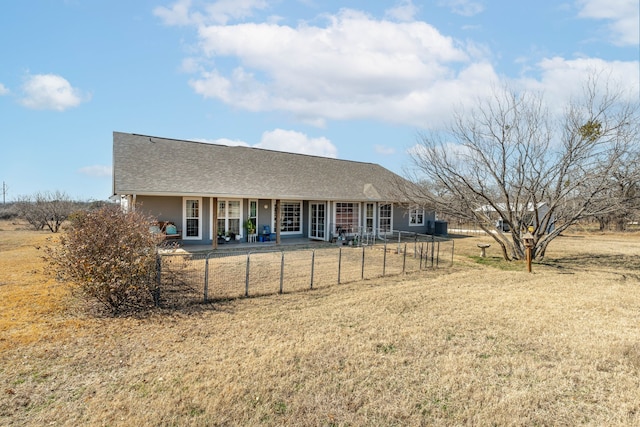 back of property with a lawn