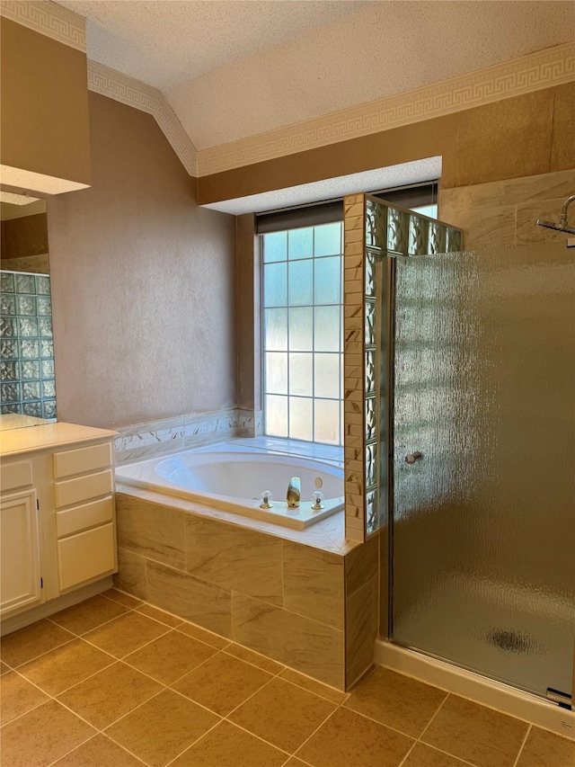 bathroom with lofted ceiling, tile patterned flooring, vanity, a textured ceiling, and independent shower and bath