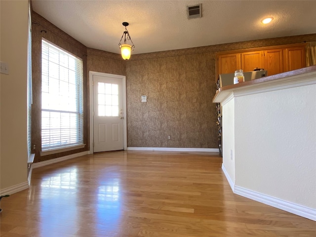 interior space with light hardwood / wood-style flooring and a textured ceiling