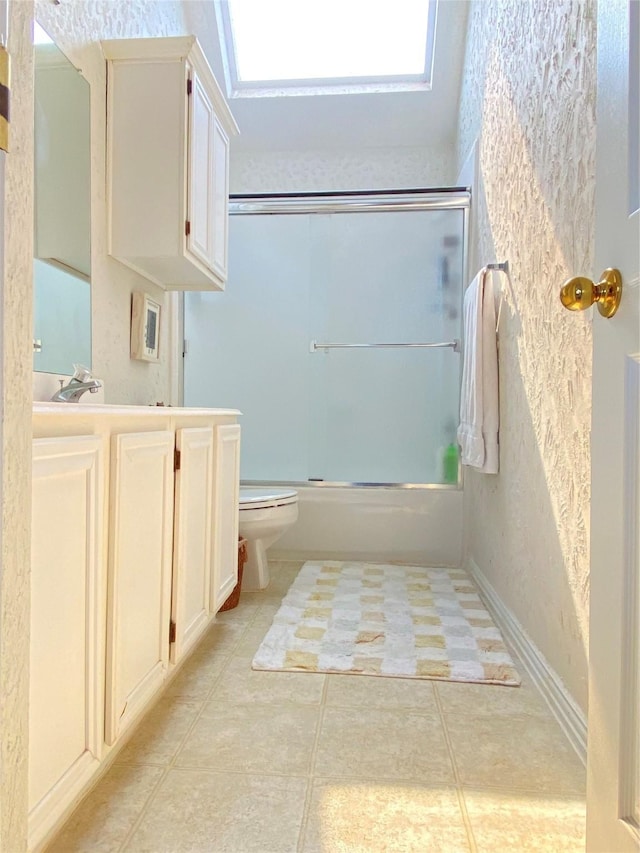 full bathroom with vanity, toilet, tile patterned flooring, and combined bath / shower with glass door