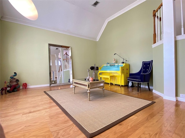 sitting room featuring lofted ceiling, hardwood / wood-style floors, and crown molding