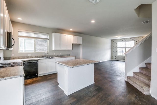 kitchen with white cabinetry, dark hardwood / wood-style floors, black appliances, and a center island