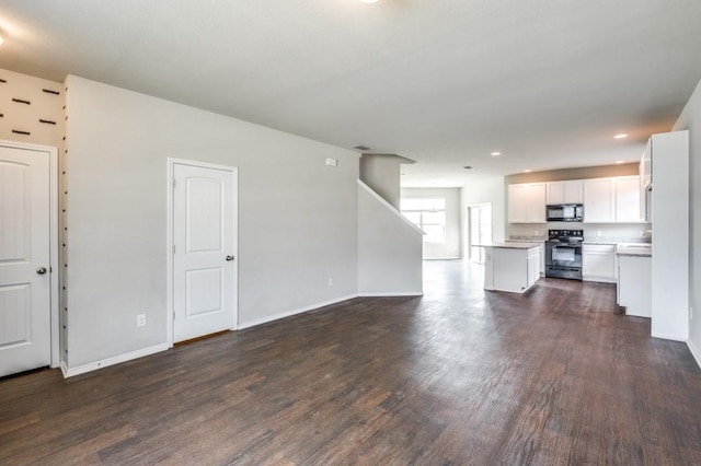 unfurnished living room featuring dark wood-type flooring