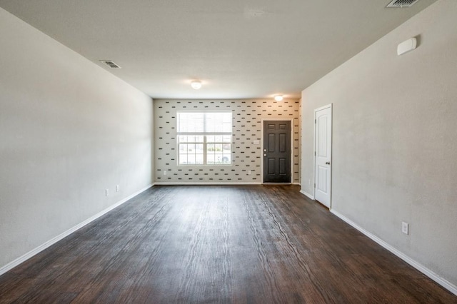 empty room with dark wood-type flooring