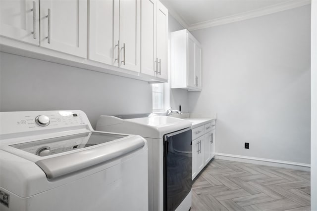 laundry room with sink, cabinets, separate washer and dryer, ornamental molding, and light parquet floors