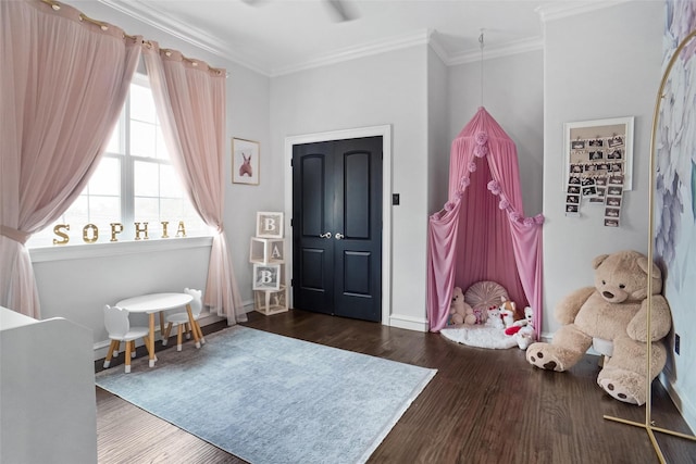 bedroom featuring ornamental molding and dark hardwood / wood-style flooring