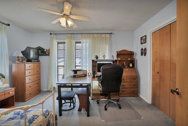 home office with ceiling fan, light carpet, and a textured ceiling