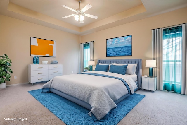 630 Celeste Ln, Burleson, TX 76028 - carpeted bedroom with multiple windows, a tray ceiling, and ceiling fan