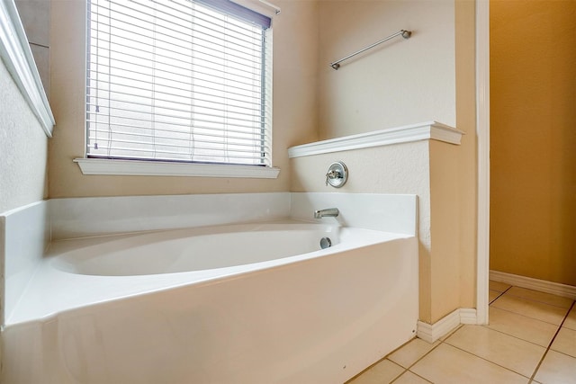 bathroom with tile patterned flooring and a bathtub