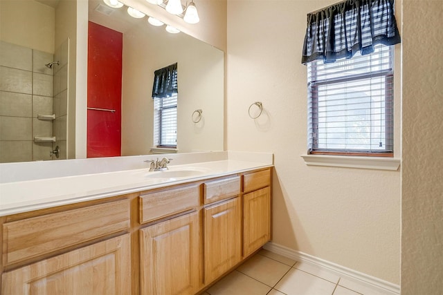 bathroom featuring vanity, tile patterned floors, and a shower