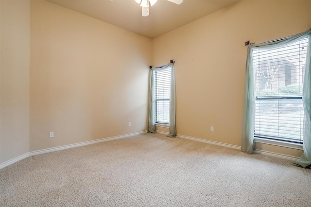 empty room featuring light carpet and ceiling fan