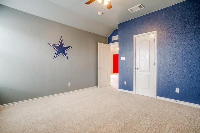 unfurnished bedroom with lofted ceiling, ceiling fan, and carpet