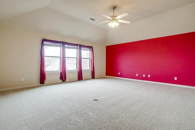 carpeted spare room featuring lofted ceiling and ceiling fan