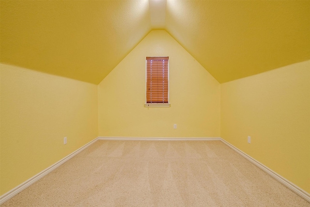 bonus room featuring lofted ceiling and carpet flooring