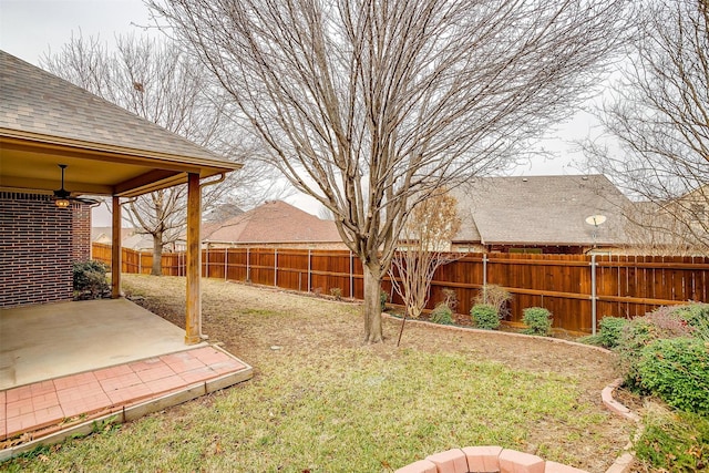 view of yard with ceiling fan and a patio area