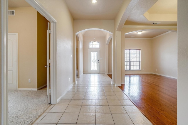 tiled foyer with ornamental molding