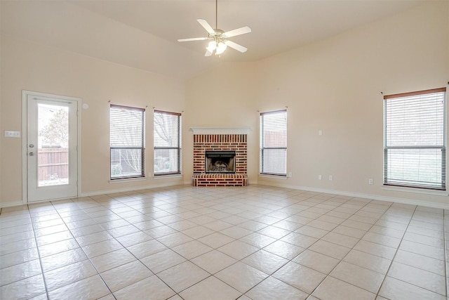 unfurnished living room featuring a wealth of natural light, light tile patterned floors, and a fireplace