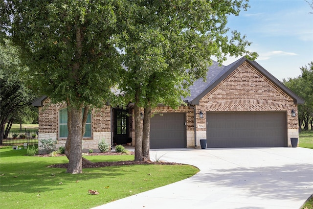 view of front facade with a garage and a front lawn