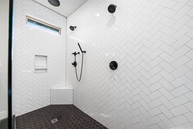 bathroom with a tile shower